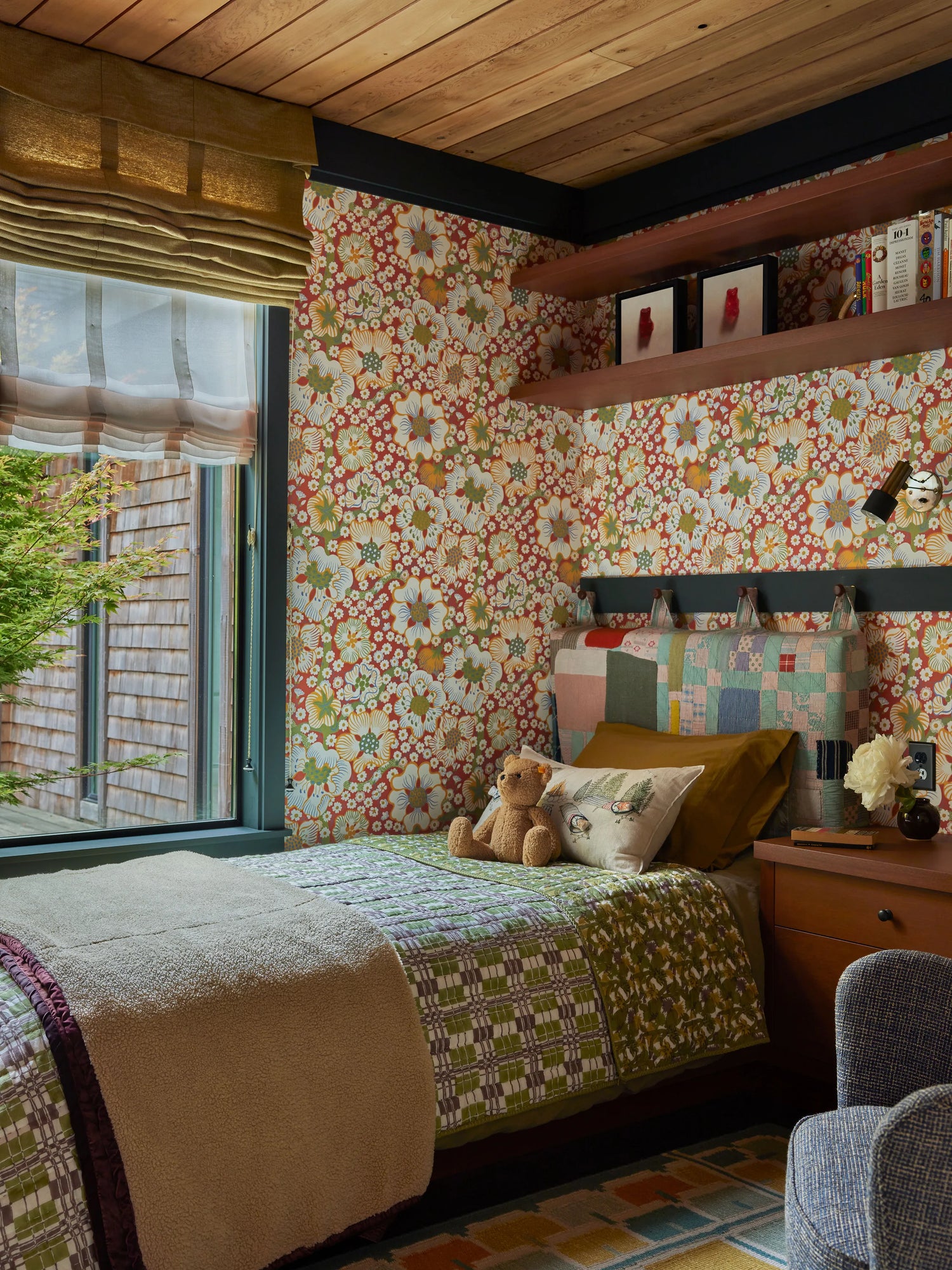 Image of kid's room featured in Architectural Digest, Coral & Tusk Stargazers pocket pillow acts as the focal point on the bed with gorgeous quilted headboard by Adam Pogue and colorful wallpaper by Josef Frank for Svenskt Tenn.