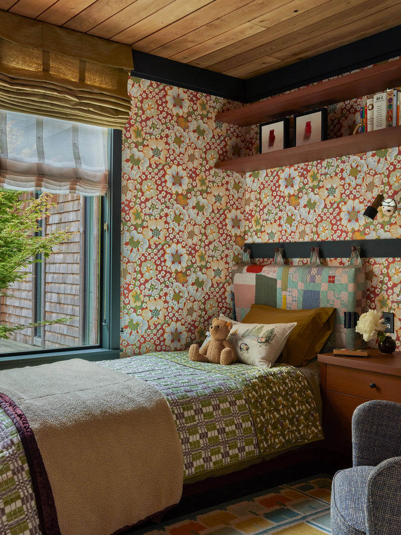 Image of kid's room featured in Architectural Digest, Coral & Tusk Stargazers pocket pillow acts as the focal point on the bed with gorgeous quilted headboard by Adam Pogue and colorful wallpaper by Josef Frank for Svenskt Tenn.