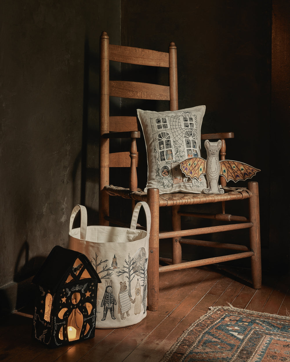 Wooden chair with Coral & Tusk Halloween Haunted house pocket pillow, felt house, full moon masquerade candy bucket and bat doll toy