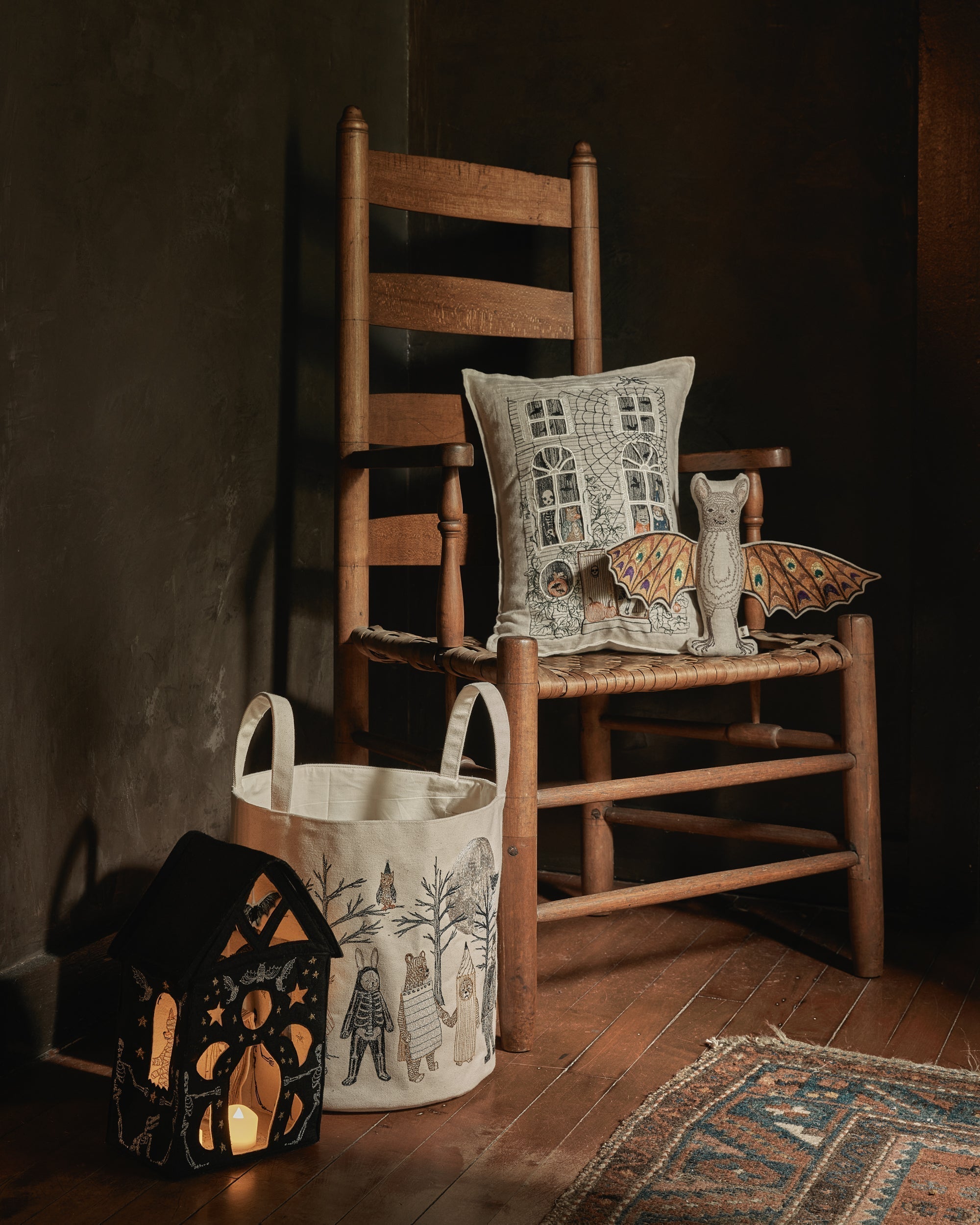 Wooden chair with Coral & Tusk Halloween Haunted house pocket pillow, felt house, full moon masquerade candy bucket and bat doll toy