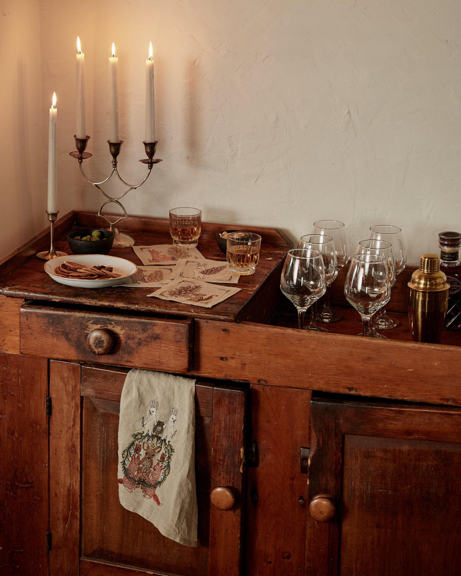 Vintage wood bar cart side table with candles and Coral & Tusk kitchen table linens