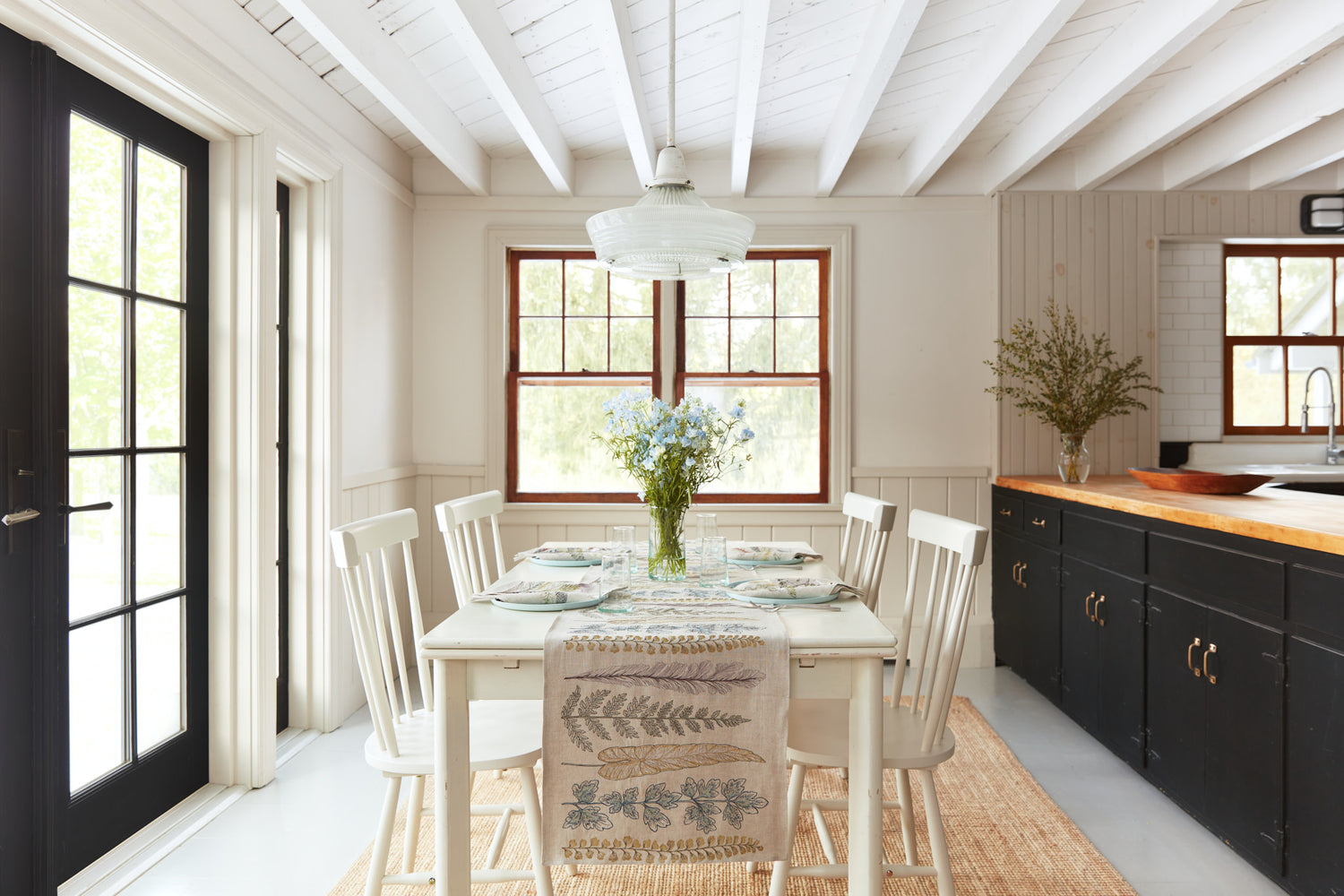 Coral & Tusk Plants Table Runner on a table set for spring