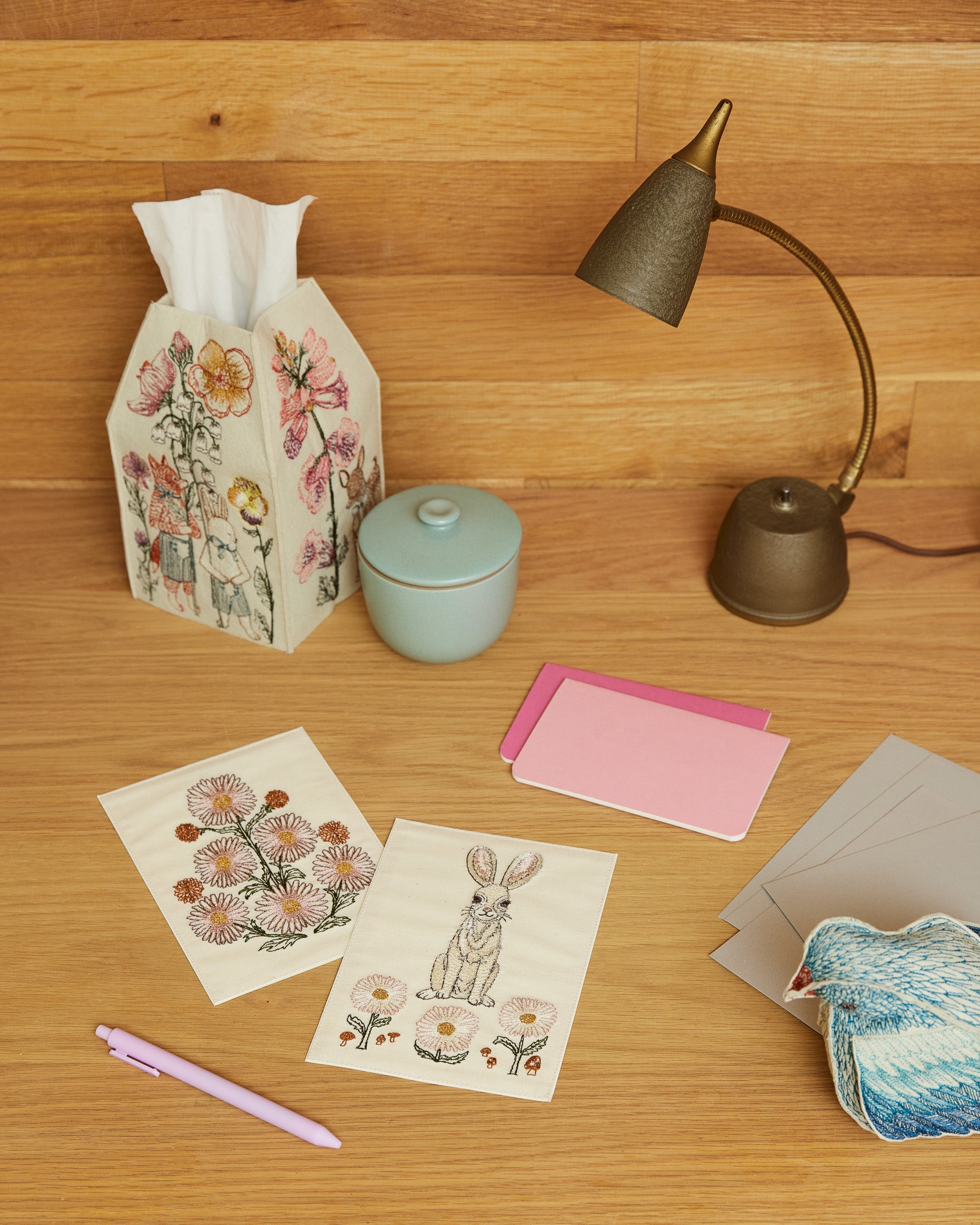 Spring Parade Tissue Box on a wood desk with cards and lamp
