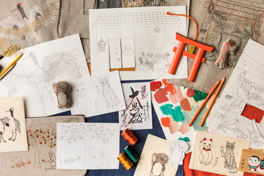 Inspiration photo overhead of Stephanie Housley's drawings, embroideries, Coral and Tusk products, for Spring 2017 collection.