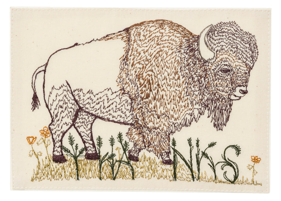 Embroidered buffalo with word 'Thanks' growing up with grasses and flowers from bottom of image