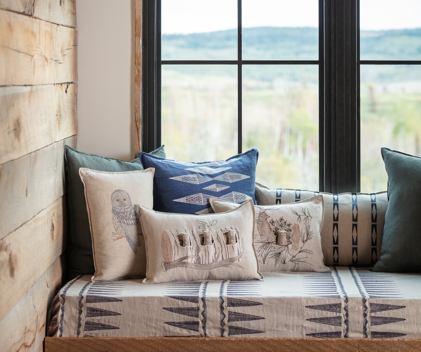 Window nook with Coral and Tusk embroidered pillows.