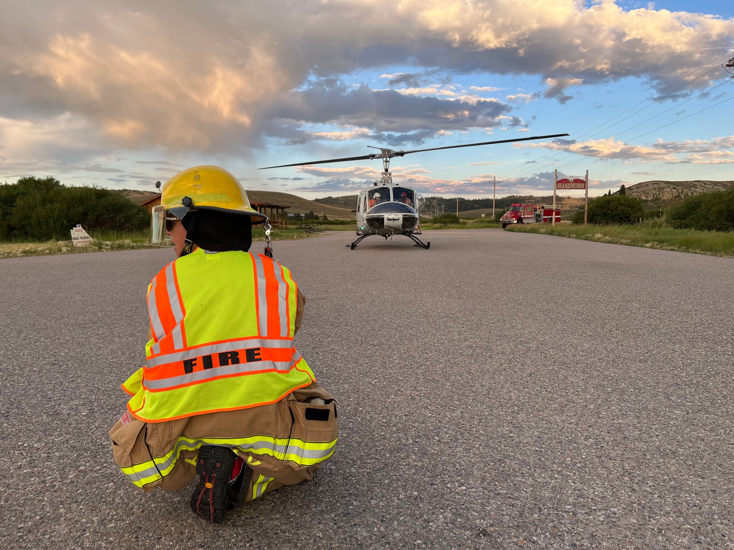 Volunteer firefighter Stephanie Housley aids a helicopter landing in Wyoming