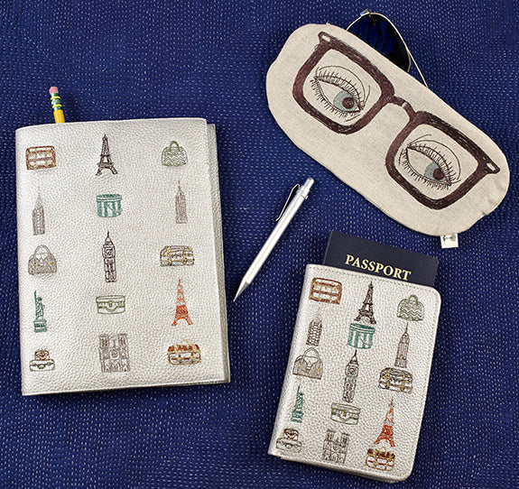 Overhead image of Coral and Tusk embroidered glasses pouch, notebook and passport holder