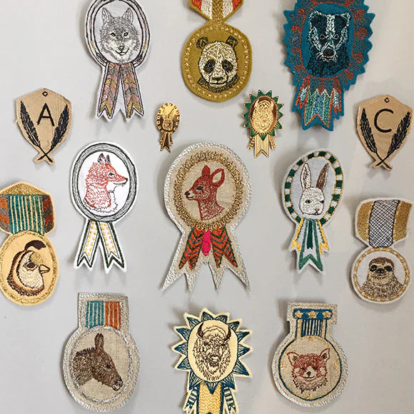 Coral and Tusk embroidered badges, overhead image of 15 different animal badge and medal designs.