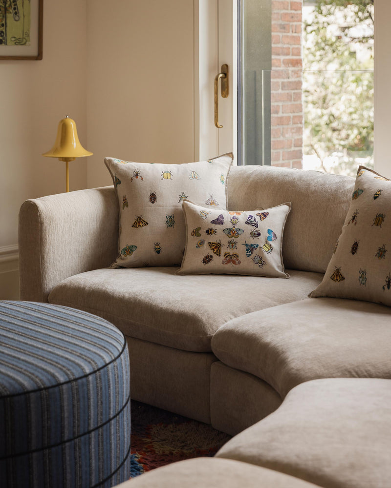 Sofa with Coral & Tusk embroidered pollinator Wings and fancy flight pillow