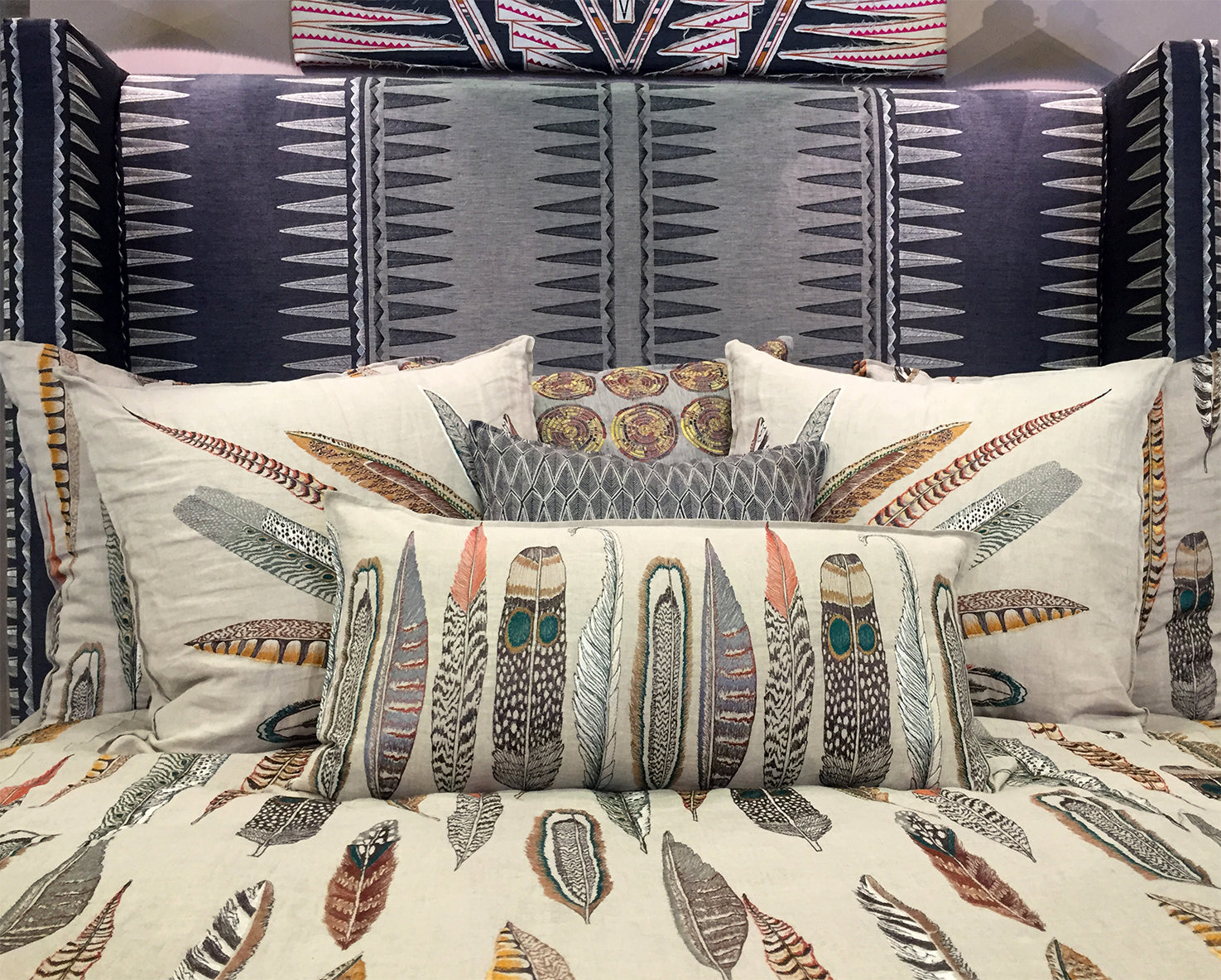 embroidered feather design linen decorative pillows on bed