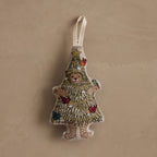 Coral & Tusk Christmas Tree Bear stuffed embroidered linen ornament featuring Bear dressed as a Christmas tree, decorated with colorful songbirds, silver metallic ornaments, gold tinsel, and a shining star, with a white cotton loop at the top for hanging.