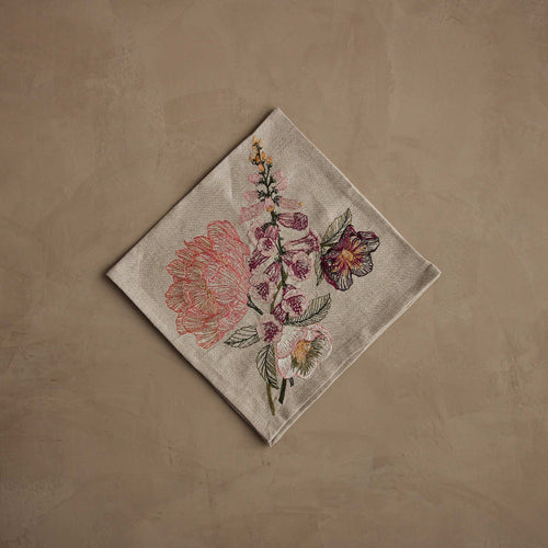 Coral & Tusk embroidered linen Blush Bouquet Dinner Napkin folded, showcasing peonies, foxgloves, and pansies in blush, pink, green, and purple tones.