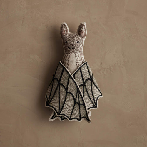 Coral & Tusk embroidered Bat Surprise Doll, a smiling bat with fabric wings shown closed.