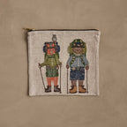 Coral & Tusk Explorers linen zipper pouch, featuring an embroidered design of two hiker animals, Bear and Fox, with backpacks, hiking outfits in blue and green, merit badges, hats, boots, and poles.