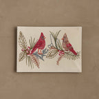 Coral & Tusk Christmas Cardinals card featuring embroidered an red male cardinal and a brown and red female cardinal perched on sprigs of green and brown holly, with small red holly berries.
