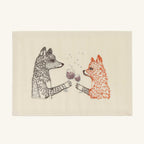 Seconds Sale Raise a Glass Card featuring detailed embroidery of a grey wolf and an orange fox toasting with red wine on a rectangular off-white card, with small embroidered bubbles rising from their clinking glasses.